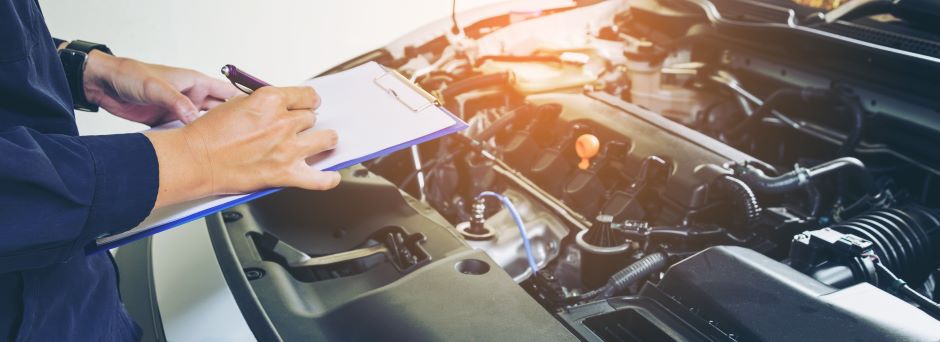 mechanic going through vehicle inspection checklist