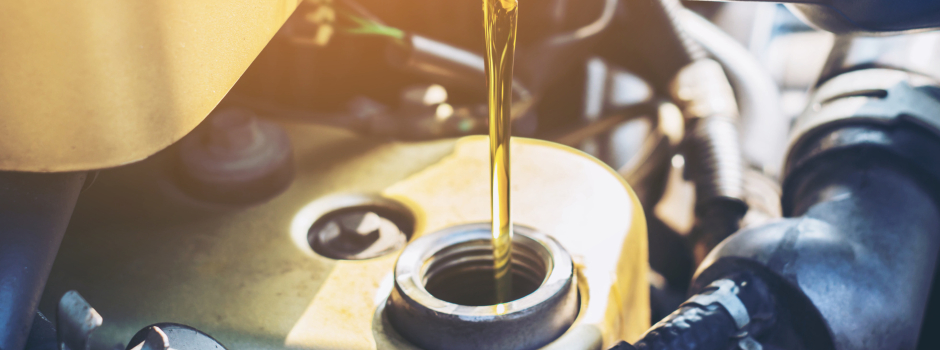 Engine oil being poured into car